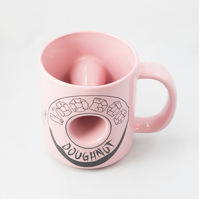 Pink coffee mug with Voodoo Logo and a hole through the middle.