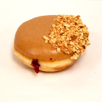 Raspberry jelly filled doughnut, peanut butter icing and chopped peanutsf dipped in chopped peanuts