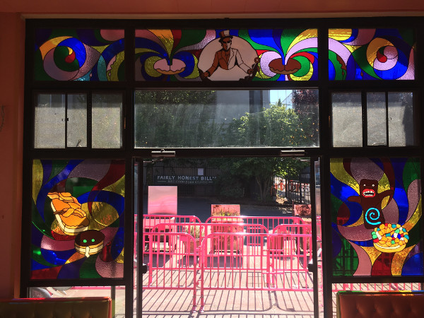 Stained glass window framing entrance to Voodoo Too shop