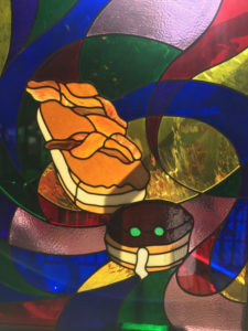 Stained Glass window showing portland cream and maple bacon bar