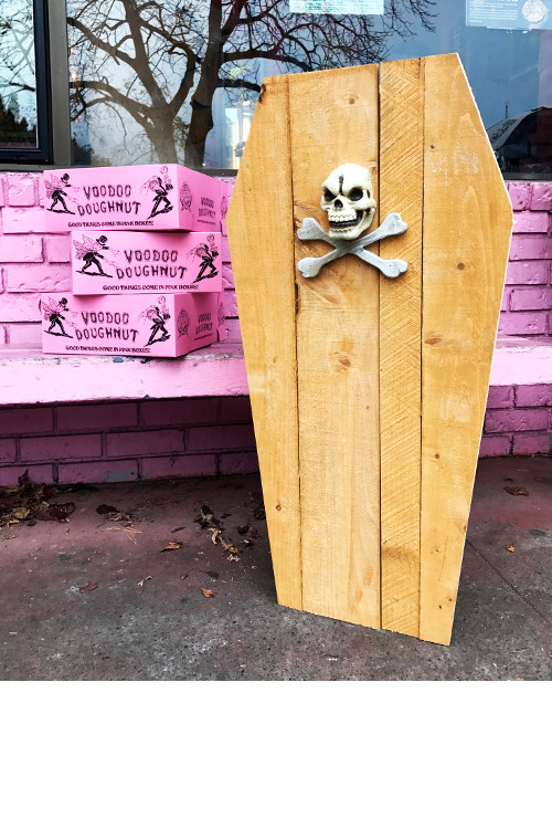 Coffin of Doughnuts upright outside with Three Pink Boxes