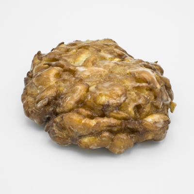 Fried dough fritter with apples and a covered in a shiny glaze.