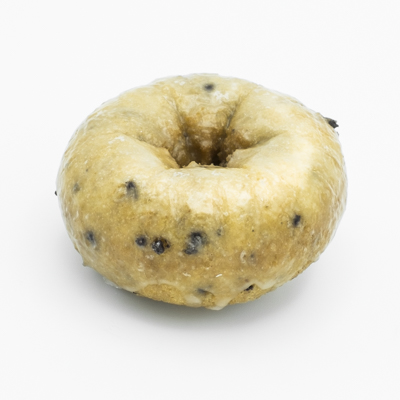 Cake doughnut with blueberries showing in the dough, and a light glaze