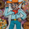 Cowboy Doughnut Centerpiece surrounded by dozen doughnuts