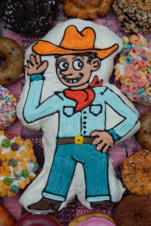 Cowboy Doughnut Centerpiece surrounded by dozen doughnuts
