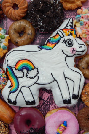 Horse-shaped and iced doughnut with rainbows and other doughnuts