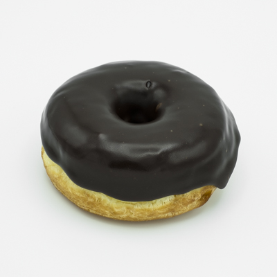 Chocolate dipped ring doughnut close up from the side.