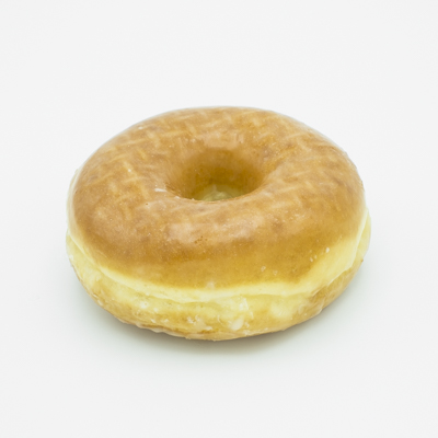 Glazed ring yeast doughnut shown close up and from the side.