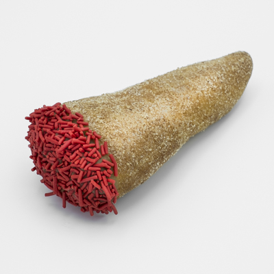 Cone-shaped doughnut, dusted with cinnamon sugar maple frosting and red sprinkles