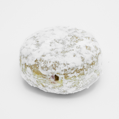 Image of a Powered Sugar Jelly Filled doughnut; a round raised yeast shell filled with raspberry jelly just peeking out, and dusted all over with powdered sugar. Shown up close and from the side.