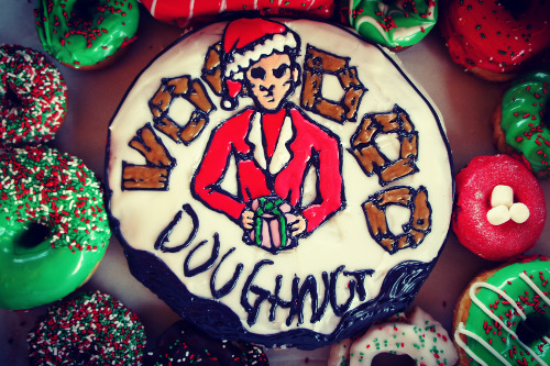 Santa Christmas Doughnut with Voodoo Doughnut Logo and other green and red doughnuts