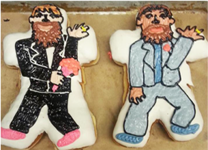 Two doughnuts shaped and frosted to look like two men in suits