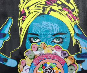 Duct Tape Mural with woman's face gazing into crystal ball-like doughnut