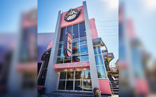 Exterior of the Universal Orlanto Resort Voodoo Doughnut store front with large logo sign
