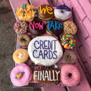 Doughnuts that have the words We Now Take Credit Cards Finally in icing.