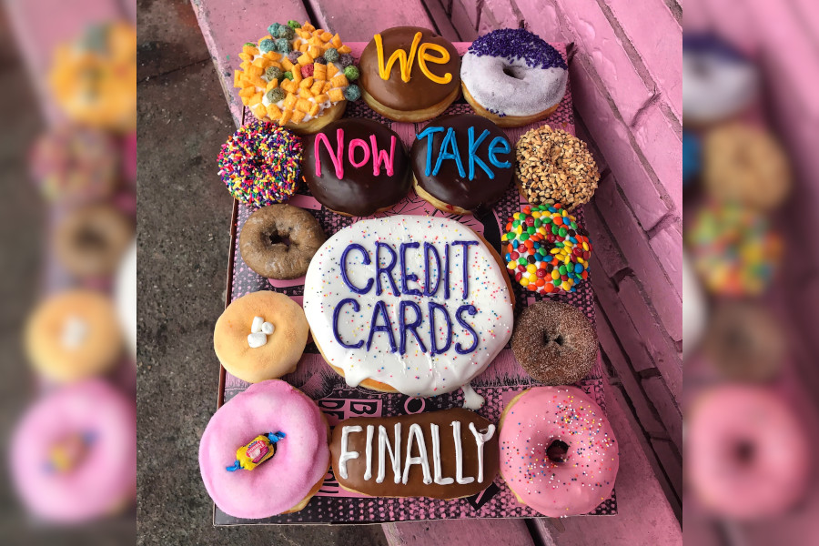 Doughnuts that have the words We Now Take Credit Cards Finally in icing.