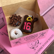 Voodoo Doll Doughnut with 16 in frosting in pink box