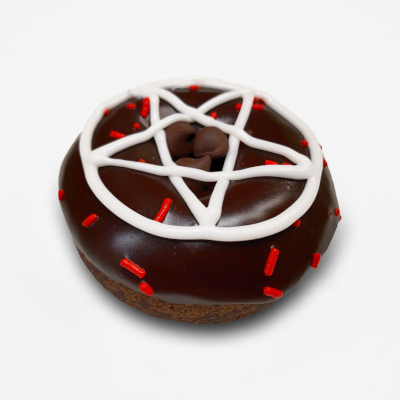Chocolate cake doughnut with chocolate frosting a white frosting pentagram, a few red sprinkles