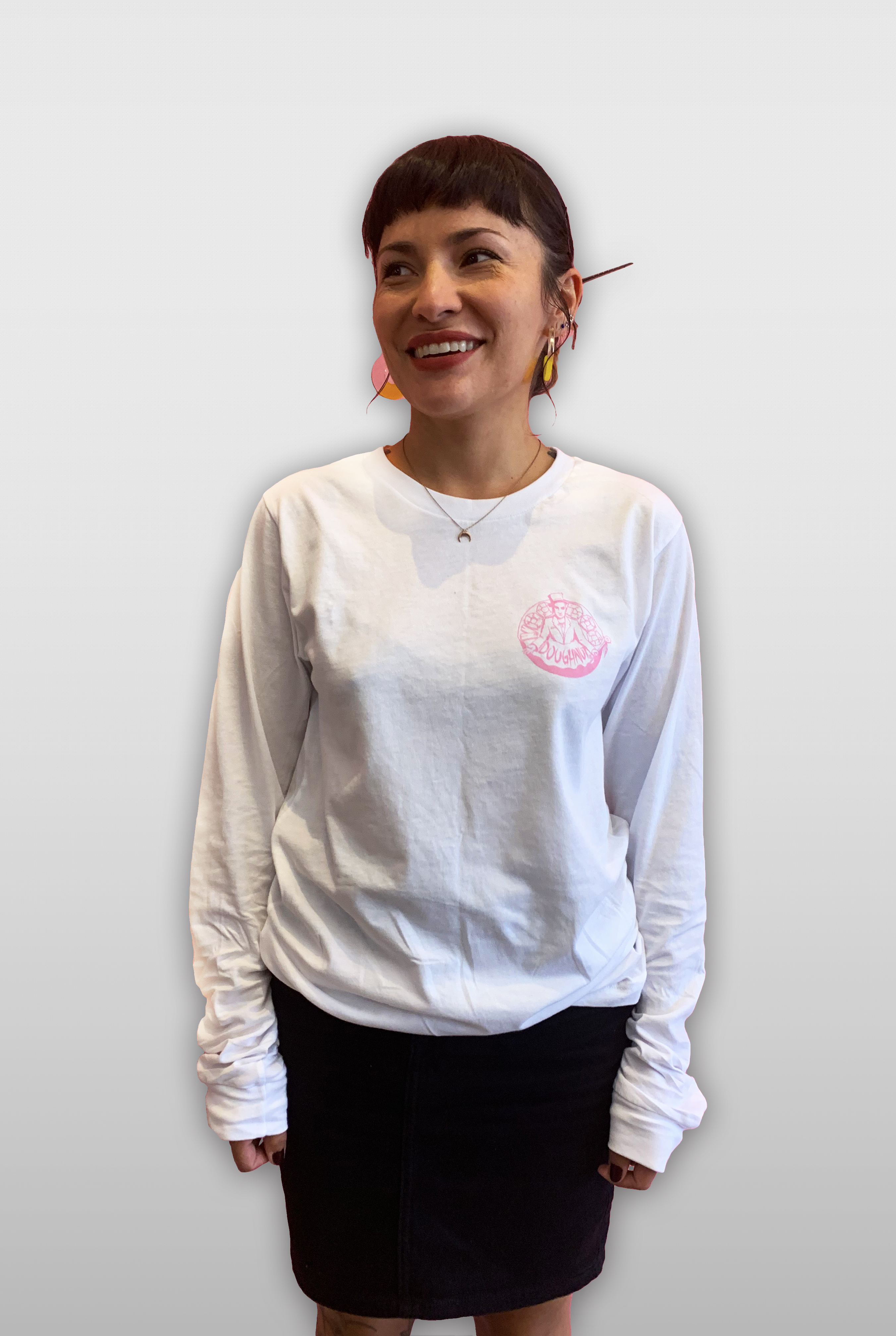 woman wearing a long sleeve white t-shirt and short skirt