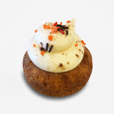 Cake doughnut with buttercream, orange and black sprinkles and pumpkin spice on top