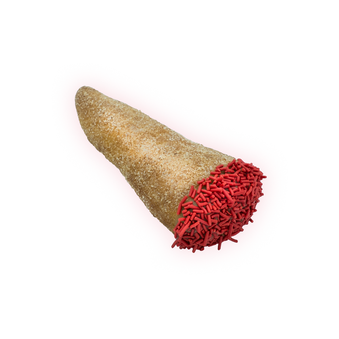 Raised blunt shape dusted with cinnamon sugar, maple frosting, and red sprinkle embers.