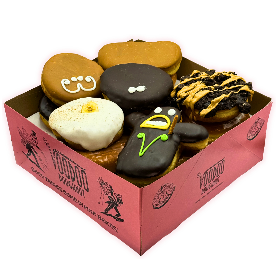 voodoo doughnut pink box filled with vegan doughnuts for the vegan dozen